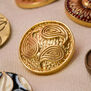 Golden paisley coat button