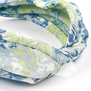 A detail of a fabric headband featuring a blue floral pattern.