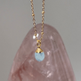 A light blue stone pendant necklace.
