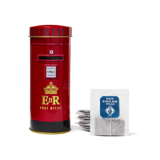 Tin tea caddy modelled on a London red post box. Five tea bags of black tea are arranged next to it.