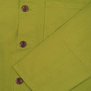 A close up of a lime green shirt, showing three brown front button.