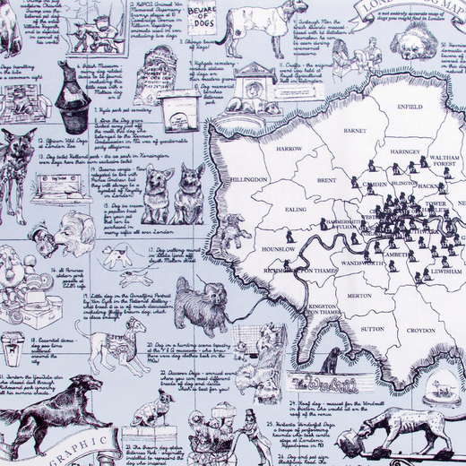 A detail of a blue and white tea towel with illustrations of dogs over a map of London.