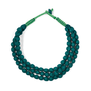 A deep blue green necklace made of three chunky strands of textile beads.