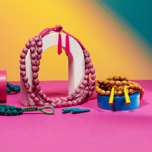 Magenta wooden earrings displayed alongside alternative colours and necklaces by the same designer
