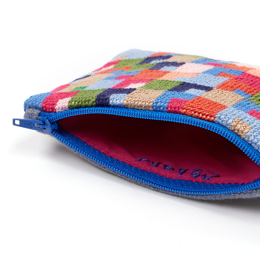 Close up of a zip pouch with a colourful embroidered pattern in blue, pink, red and green.