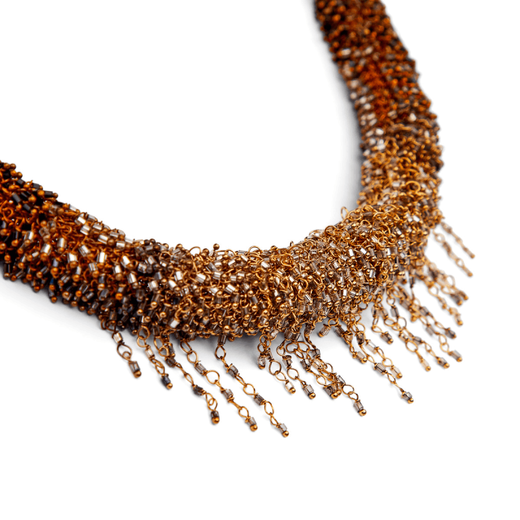 A close up of a brass beaded necklace.