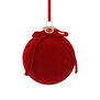 Bright christmas bauble covered with a red vellved fabric 