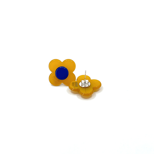 A pair of flower shaped stud earrings with a blue centre and yellow petals. One earring is laid upside down to show the back.