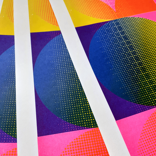 Detail of a risograph print featuring colourful geometric shapes and a white border.