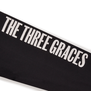 A detail of a black long sleeve with the words The Three Graces printed in white capital letters.