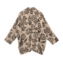 The back of a long sleeve jacket featuring a floral black pattern on a cream background.