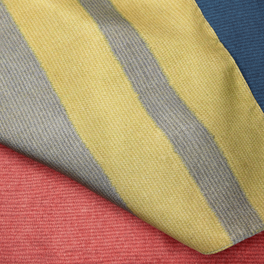 Detail of a yellow, cream and red silk fabric.