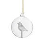 Glass bauble with a bird nestled inside