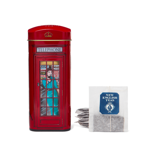Tin tea caddy modelled on a London red phone box. Five tea bags of black tea are arranged next to it.