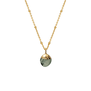 Gold chain necklace with a pale green stone pendant.