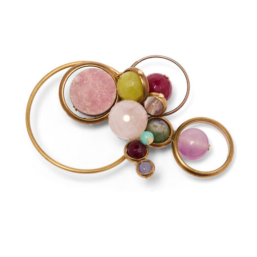 Brooch featuring pastel pink and green beads set on brass hoops.