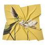 A square shaped scarf featuring a lotus flower on a yellow background, wrapped up in the middle. 