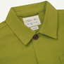 A detail of a lime green shirt's nape.