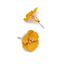 Two yellow flower-shaped stud earrings are displayed on a white surface. 