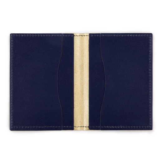An open leather card wallet. The inside is dark blue and gold.