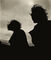 Silhouette of two women sitting in a boat