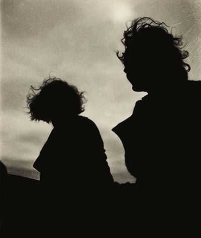 Silhouette of two women sitting in a boat