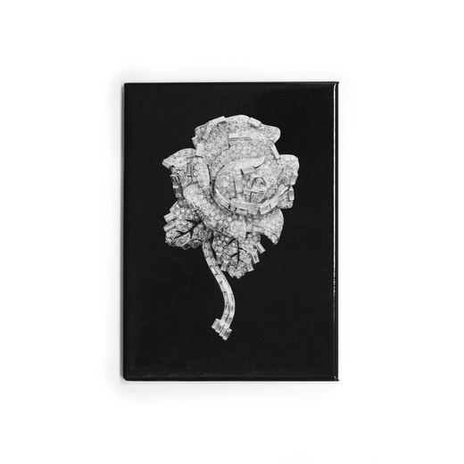 A rectangular magnet featuring a floral brooch made from layered diamonds