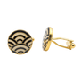 A pair of gold cufflinks with a black and white pattern.