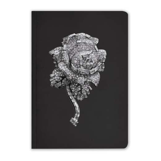 The cover of this black, lined notebook features a rose-shaped brooch of layered diamonds, by Cartier
