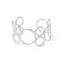 A silver cuff bracelet made up of interlocking hoops of various sizes.