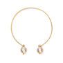 An adjustable bracelet made of a gold band and two white faux pearls descending from its extremities.