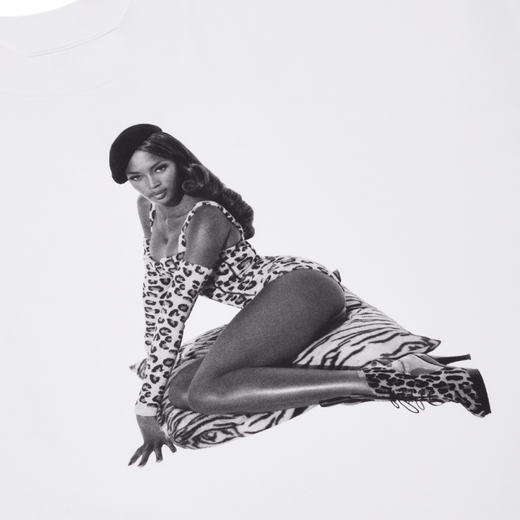 A detail of a white t-shirt featuring a black and white photograph of a model in leopard printed outfit.