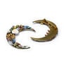Two brooches in the shape of a crescent moon. One is made of colourful stones and glass beads while the other is turned to show the clasp at its back.