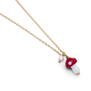 The detail of a chain necklace with a small red mushroom pendant.