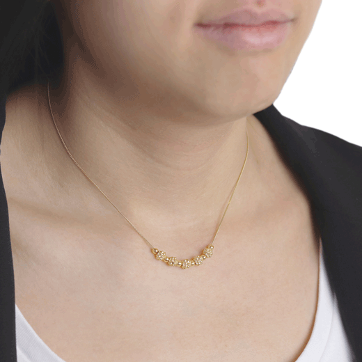 Ornate gold bead necklace by Mounir