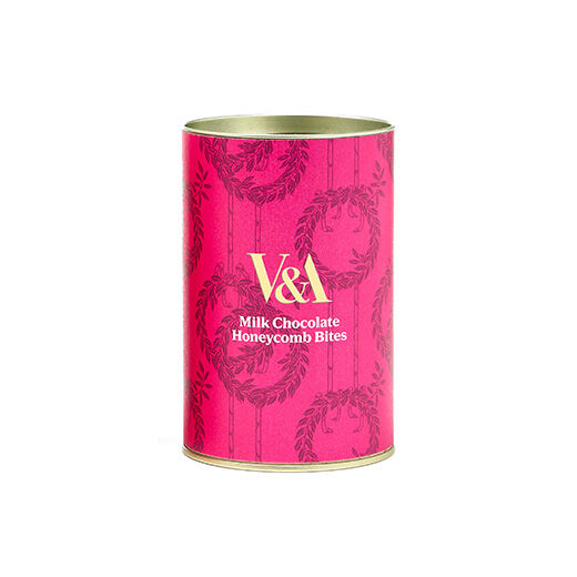 A drum containing chocolate coated honeycomb bites, wrapped in a hot pink paper label with the V&A logo in white capital letters.