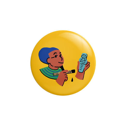 A yellow button badge featuring a cartoonish illustration of the Egyptian god Ptah.