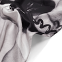 A detail of a black and white silk scarf.