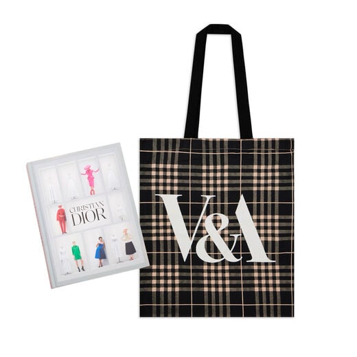 A hardback featuring five models wearing colourful clothes on a grey cover. The book is laid next to a pink and black tartan tote bag.