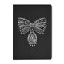 A black notebook featuring a bow-shaped brooch of carved rock crystal and diamond 