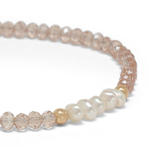 A close up of the pearls and faceted beads. 
