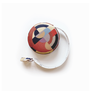 A round tape measure featuring a geometric art deco pattern.