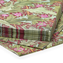 A stack of paper napkins featuring a green and red botanical Arts & Crafts pattern by John Henry Dearle.