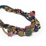 A detail shot of a green bracelet with multicoloured beads.