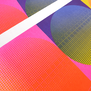 Detail of a risograph print featuring colourful geometric shapes in hot pink and blue with a white border.