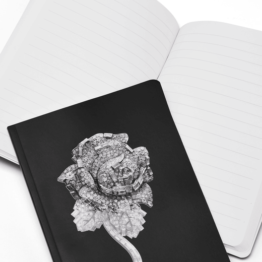 The notebook shown open reveals broad lined pages 