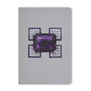 A grey pocket-sized notebook featuring an angular diamond brooch with a large purple amethyst at its centre