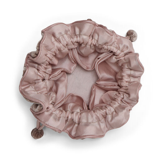 Pink velvet drawstring pouch with inner pockets for storing jewellery.