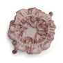 Pink velvet drawstring pouch with inner pockets for storing jewellery.