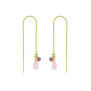 A pair of pull through earrings with a gold chain and pink stones.
